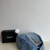 693047f8f09edb6de4c4e013 Chanel Washed Denim 25C Hobo Bag with Quilted Ball Texture, Vintage Coin Buckle Drawstring Bucket Bag in Retro Black and Gold with Diamond Stitching and Classic Chain Design
