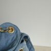 693047fff09edb6de4c4e018 Chanel Washed Denim 25C Hobo Bag with Quilted Ball Texture, Vintage Coin Buckle Drawstring Bucket Bag in Retro Black and Gold with Diamond Stitching and Classic Chain Design