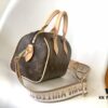 M46222 Beige M46234 Black [M45957 Black Adjustable Strap Not Available] ~ This Speedy Bandoulière 20 Handbag features Monogram canvas, cowhide leather trim, and textile lining, continuing the classic Louis Vuitton Speedy travel bag design in a compact size, complete with rolled leather handles and a detachable, adjustable fabric shoulder strap accented with signature woven branding