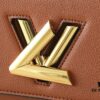 69305eddf09edb6de4c50264 Upgraded Original M21590 M59090 Twist One Handle BB Handbag crafted from deeply dyed Taurillon leather, featuring a top single handle and the iconic LV Twist turn-lock flap closure. The contrasting color leather lining adds a fashionable touch, suitable for crossbody, shoulder, or handheld wear.
