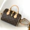 M46222 Beige M46234 Black [M45957 Black Adjustable Strap Not Available] ~ This Speedy Bandoulière 20 Handbag features Monogram canvas, cowhide leather trim, and textile lining, continuing the classic Louis Vuitton Speedy travel bag design in a compact size, complete with rolled leather handles and a detachable, adjustable fabric shoulder strap accented with signature woven branding