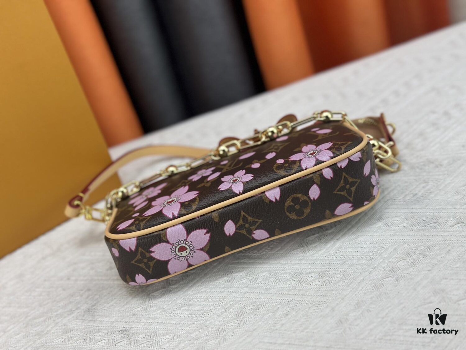 69306f3a6e68136f4d9a5740 M13666 Pochette Accessoires Bag – A playful interpretation of the iconic Monogram canvas with Takashi Murakami's vibrant Cherry Blossom motif, revisiting the Louis Vuitton x Murakami collaboration with bold, whimsical style.