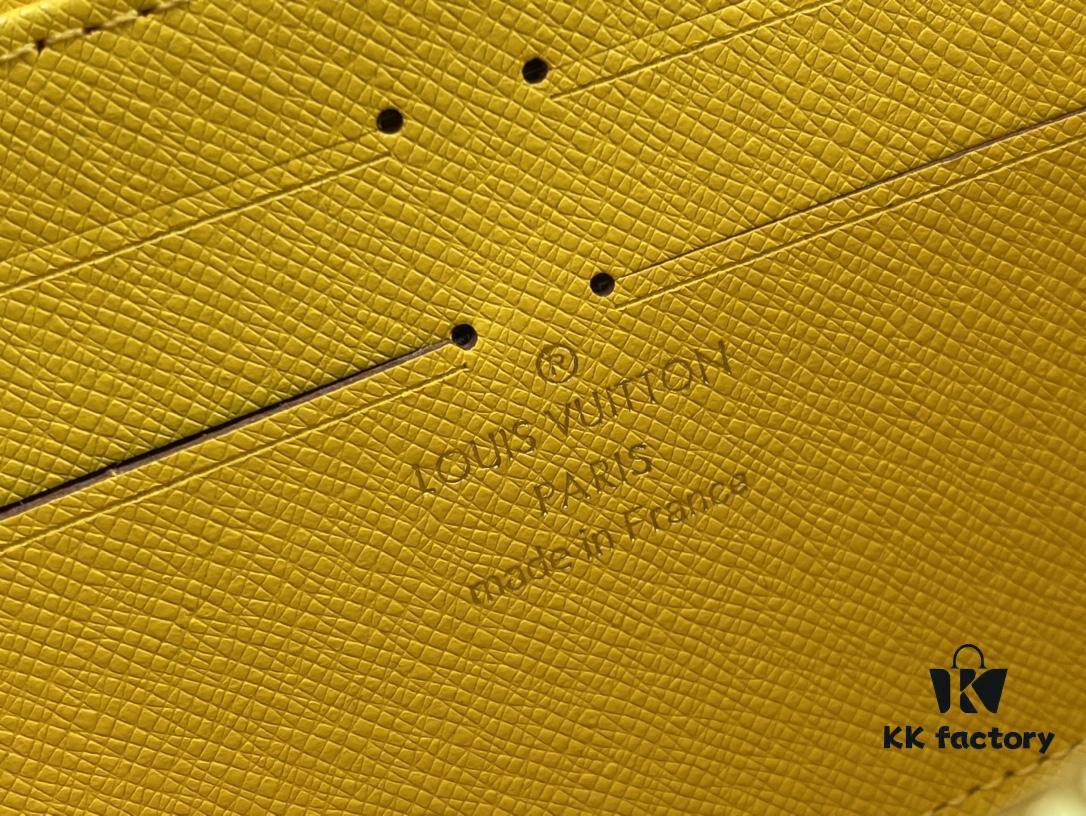 Wallet M80767 Imprint - A collectible multi-compartment zip-around wallet crafted from Monogram canvas, part of the Vivienne Holidays 2022 collection, featuring an exquisite print of Louis Vuitton's mascot Vivienne standing in front of the brand's avant-garde Tokyo boutique with Japan's iconic Mount Fuji in the background. This vibrant and sophisticated wallet serves as an invitation to journey and makes a perfect gift.