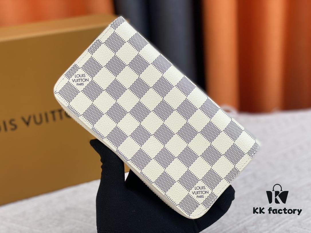 693070ef6e68136f4d9a5a1f Wallet M82839 White Check This collectible multi-compartment zip wallet is crafted from Monogram canvas from the Vivienne Holidays 2022 collection, featuring a delicate print of Vivienne, Louis Vuitton's mascot, standing in front of the brand's avant-garde Tokyo boutique with Japan's iconic Mount Fuji in the background. This vibrant high-end wallet feels like an invitation to travel and makes a perfect gift.