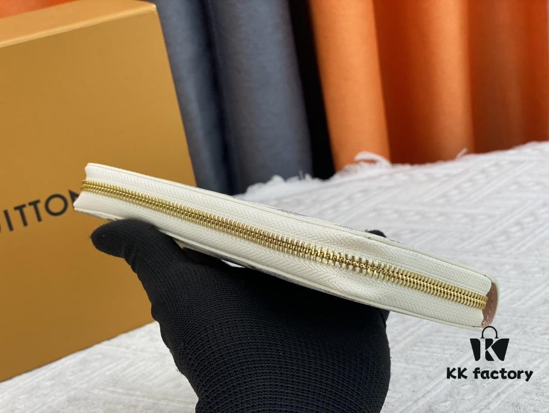 693070f06e68136f4d9a5a22 Wallet M82839 White Check This collectible multi-compartment zip wallet is crafted from Monogram canvas from the Vivienne Holidays 2022 collection, featuring a delicate print of Vivienne, Louis Vuitton's mascot, standing in front of the brand's avant-garde Tokyo boutique with Japan's iconic Mount Fuji in the background. This vibrant high-end wallet feels like an invitation to travel and makes a perfect gift.
