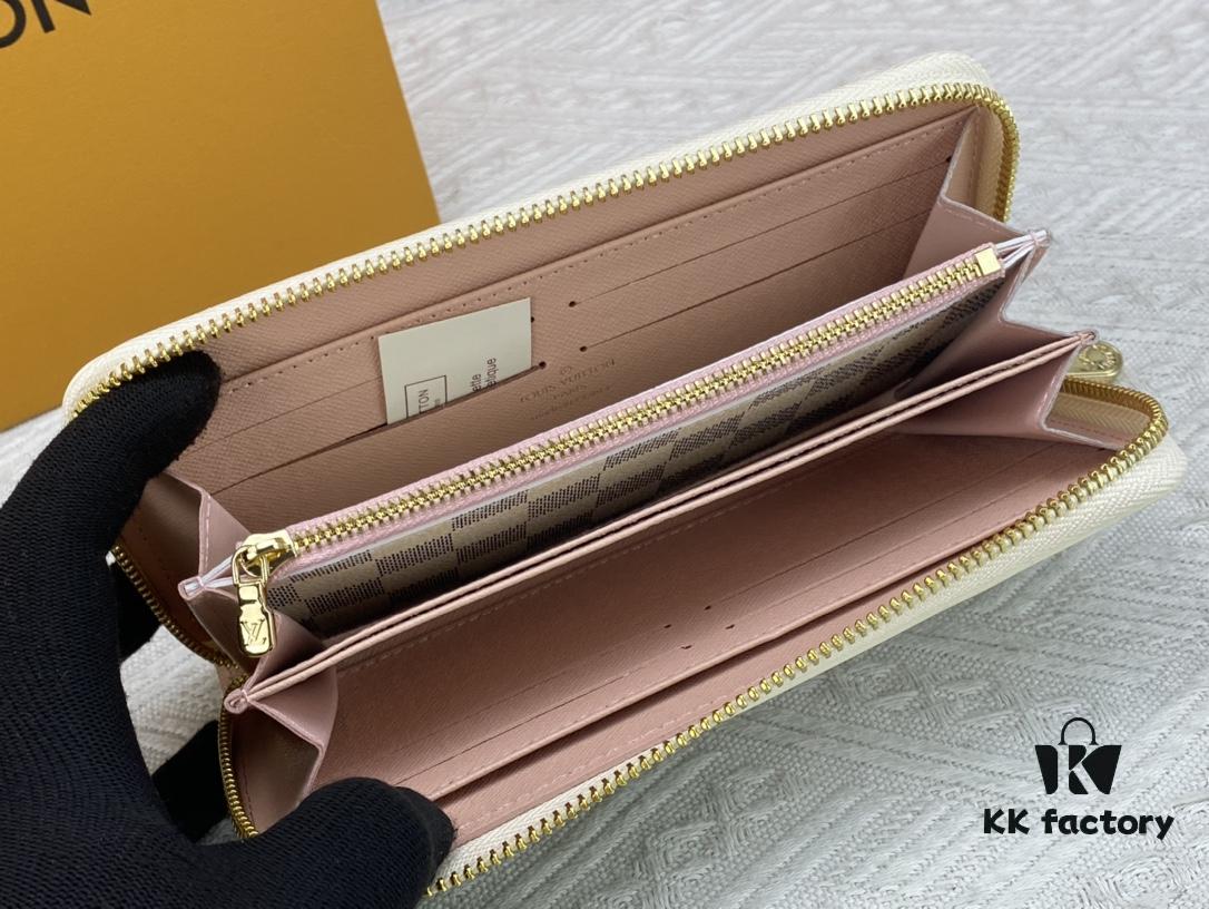 693070f16e68136f4d9a5a24 Wallet M82839 White Check This collectible multi-compartment zip wallet is crafted from Monogram canvas from the Vivienne Holidays 2022 collection, featuring a delicate print of Vivienne, Louis Vuitton's mascot, standing in front of the brand's avant-garde Tokyo boutique with Japan's iconic Mount Fuji in the background. This vibrant high-end wallet feels like an invitation to travel and makes a perfect gift.
