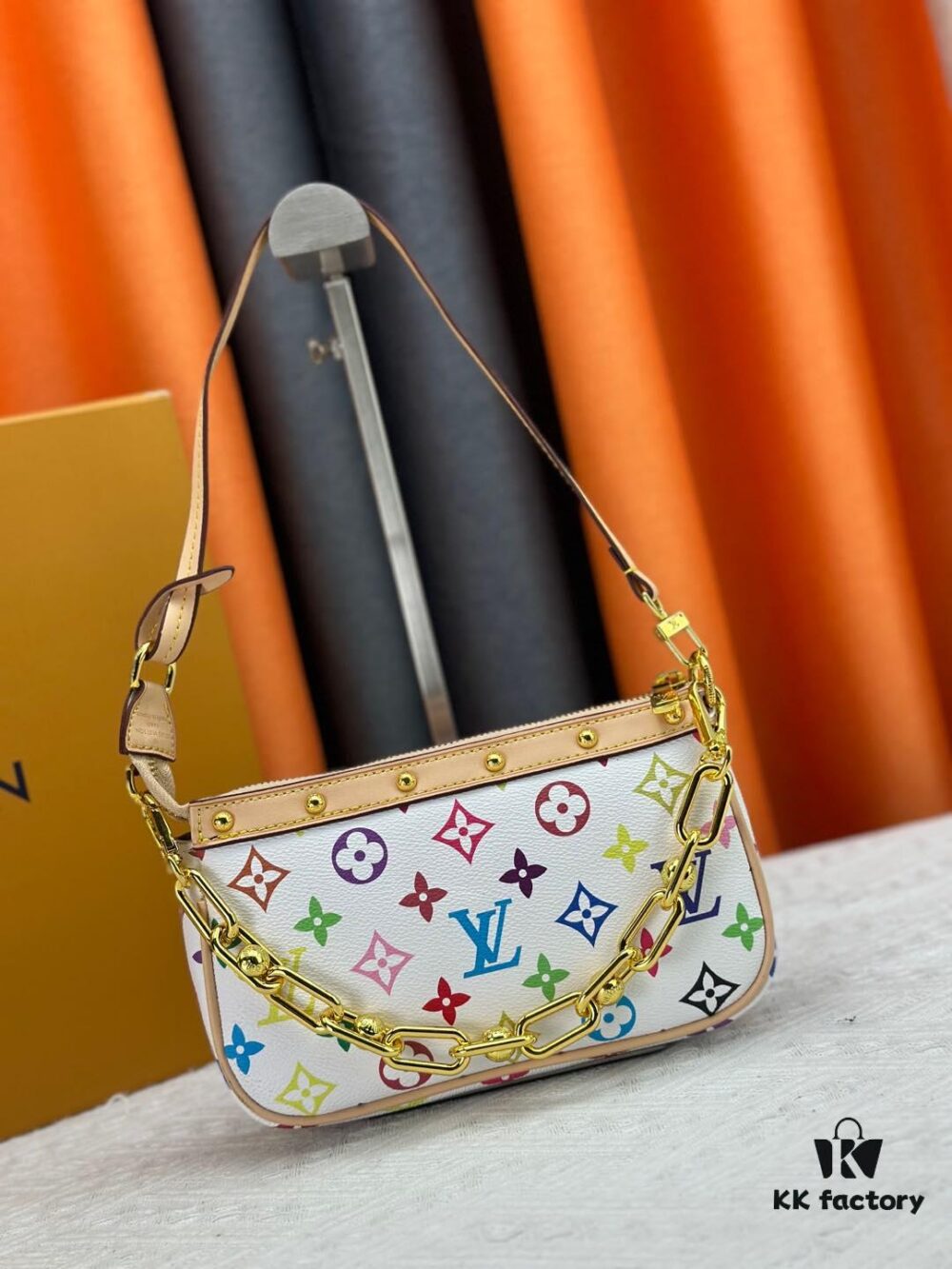693071426e68136f4d9a5ac5 M13404 M13663 Black Color White Color This Pochette Accessoires handbag is crafted from coated canvas featuring a vibrant Monogram pattern, showcasing the dynamic style of the Louis Vuitton × Takashi Murakami collaboration collection