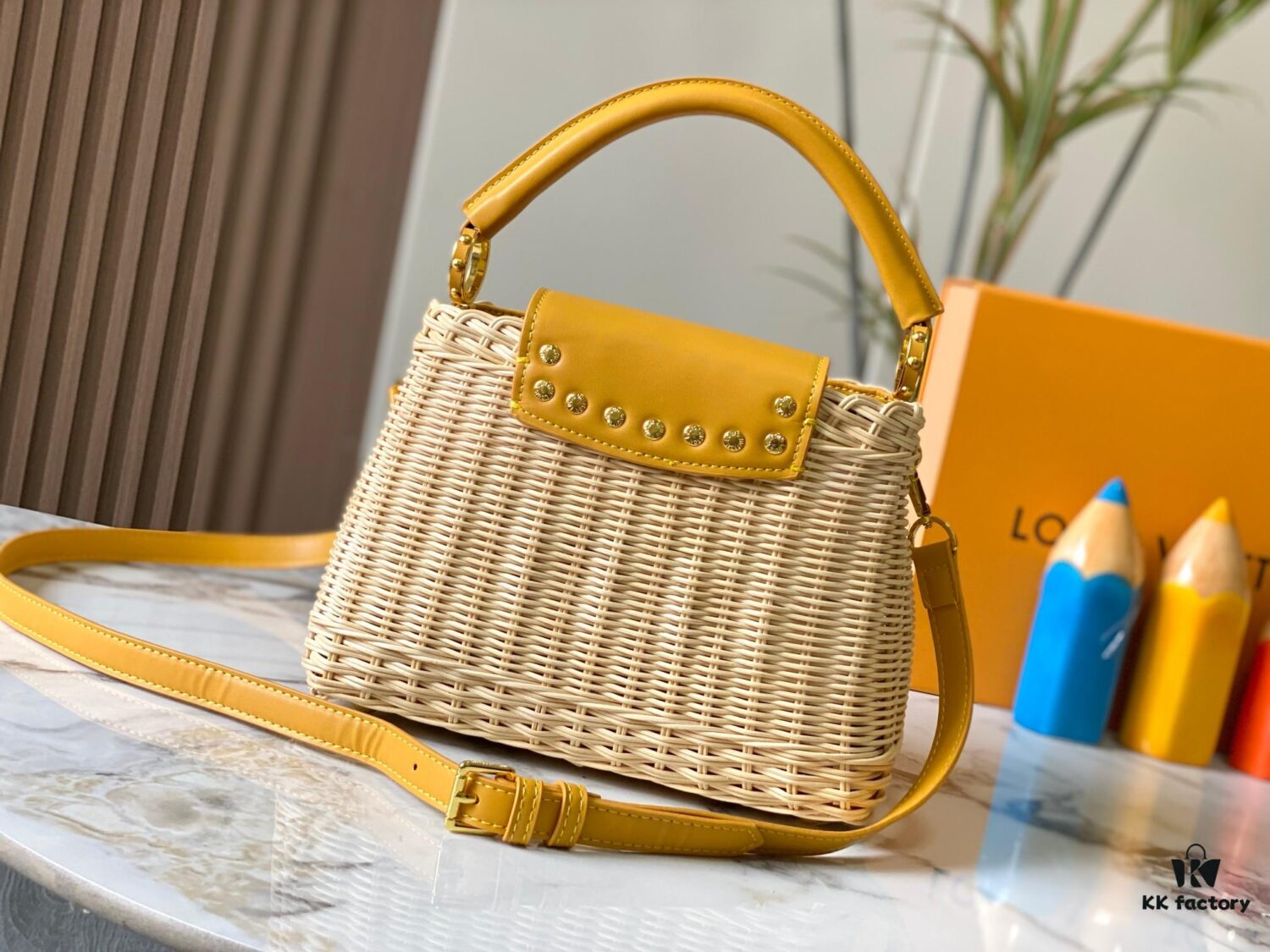 Upgraded M11617 Capucines BB Handbag featuring a woven rattan design inspired by the 1892 Louis Vuitton picnic trunk, crafted with cowhide leather handles and flap, metallic LV logo, detachable and adjustable leather shoulder strap for crossbody wear. Packaging may vary based on availability.