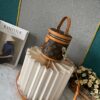 Upgraded Version [Exclusive Real Photo M82952 Damier Azur and Sunflower] This Nano Cannes Handbag features a cylindrical silhouette crafted from Monogram canvas, echoing the design of a makeup pouch.