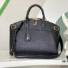 693077d96e68136f4d9a681f M22914 Black Lock It MM Bag in Refined Taurillon Leather with Gold-Tone Hardware