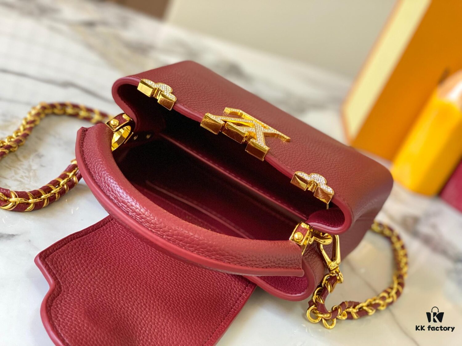 69307f1a6e68136f4d9a74fc Top Quality Original Guangzhou M24583 Date Red and Gold Diamond Flower Crown Capucines Handbag