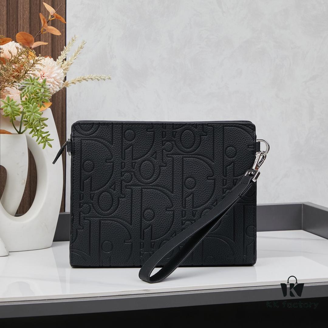 693095a86e68136f4d9aa2a6 Dior Envelope Clutch with Box ||| Crafted from premium calf leather, this Dior envelope clutch draws inspiration from the brand's archives, featuring a signature Dior logo plaque on the front for elevated sophistication. Spacious zip compartment fits most smartphones, complemented by six card slots. Includes a detachable grained calfskin wrist strap with lobster clasp for versatile carrying options—either handheld or tucked into a larger handbag.