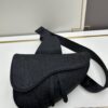 693097266e68136f4d9aa5e9 This boxed saddle bag is a new piece from the classic collection, meticulously crafted from black grained leather. A magnetic flap conceals a zip pocket for daily essentials, and it features an adjustable Christian Dior jacquard webbing strap for shoulder or crossbody wear.