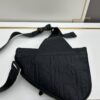 693097276e68136f4d9aa5ea This boxed saddle bag is a new piece from the classic collection, meticulously crafted from black grained leather. A magnetic flap conceals a zip pocket for daily essentials, and it features an adjustable Christian Dior jacquard webbing strap for shoulder or crossbody wear.