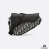 69309d056e68136f4d9ab145 This saddle bag reinterprets the classic design with a modern structure. Crafted from beige and black Oblique printed fabric, it features a signature black grained cowhide magnetic flap and a concealed zip closure. The interior includes a large compartment and slip pockets for daily essentials. The mini style comes with an adjustable, detachable leather shoulder strap, allowing for handheld, shoulder, or crossbody wear.