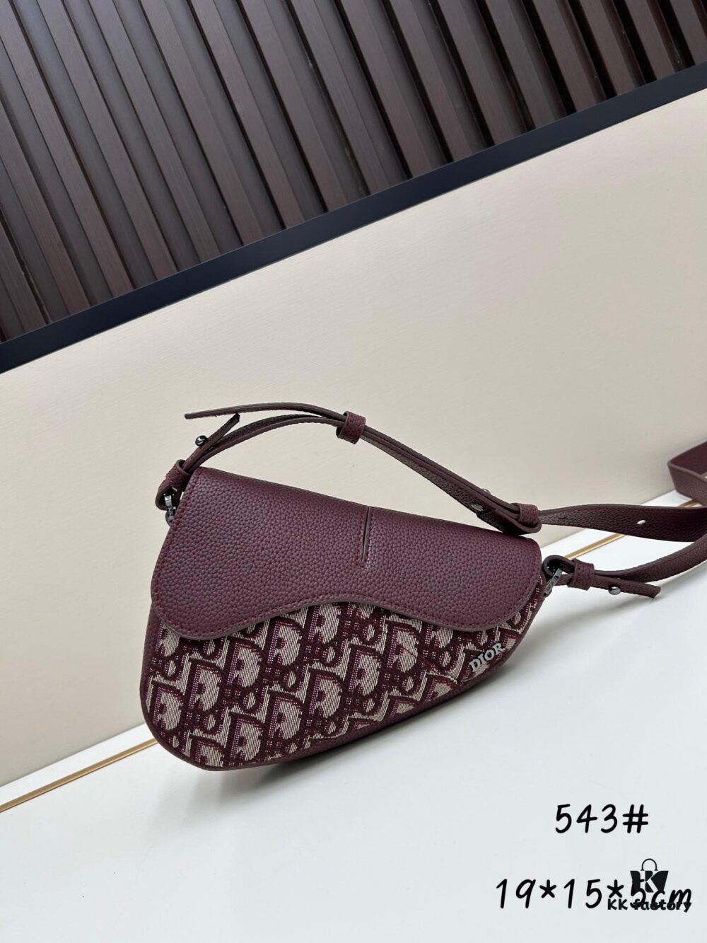 69309d0b6e68136f4d9ab150 This saddle bag reinterprets the classic design with a modern structure. Crafted from beige and black Oblique printed fabric, it features a signature grained black calfskin magnetic flap and hidden zip closure. The interior includes a spacious compartment and slip pocket for daily essentials. The mini style comes with an adjustable, detachable leather shoulder strap, allowing for handheld, shoulder, or crossbody wear.