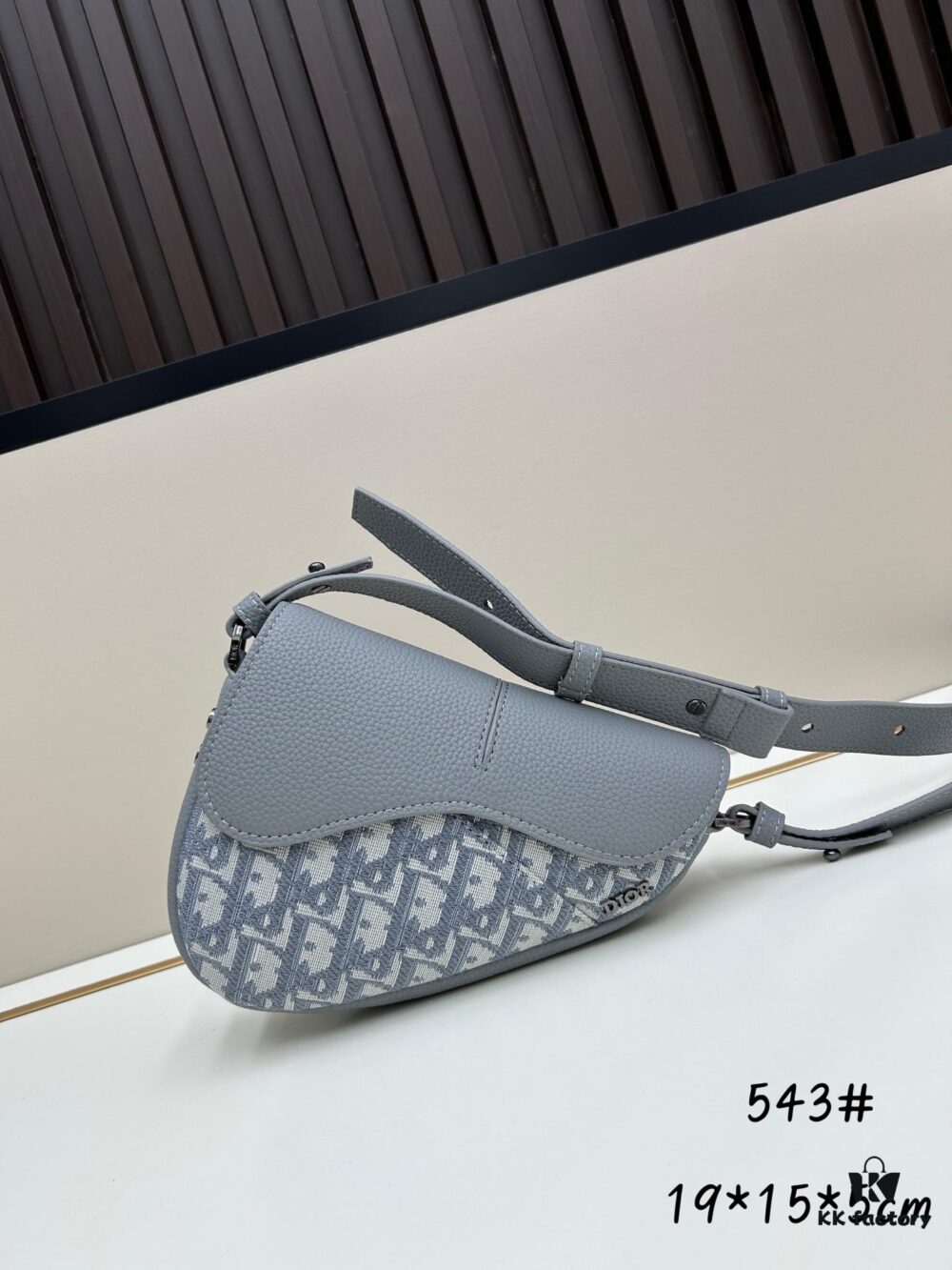 69309d0b6e68136f4d9ab151 This saddle bag reinterprets the classic design with a modern structure. Crafted from beige and black Oblique print fabric, it features a signature black grained calfskin magnetic flap and a concealed zip closure. The interior includes a large compartment and slip pockets for organizing daily essentials. The mini style comes with an adjustable, detachable leather shoulder strap, allowing for handheld, shoulder, or crossbody wear.