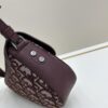 69309d126e68136f4d9ab15c This saddle bag reinterprets the classic design with a modern structure. Crafted from beige and black Oblique printed fabric, it features a signature grained black calfskin magnetic flap and hidden zip closure. The interior includes a spacious compartment and slip pocket for daily essentials. The mini style comes with an adjustable, detachable leather shoulder strap, allowing for handheld, shoulder, or crossbody wear.