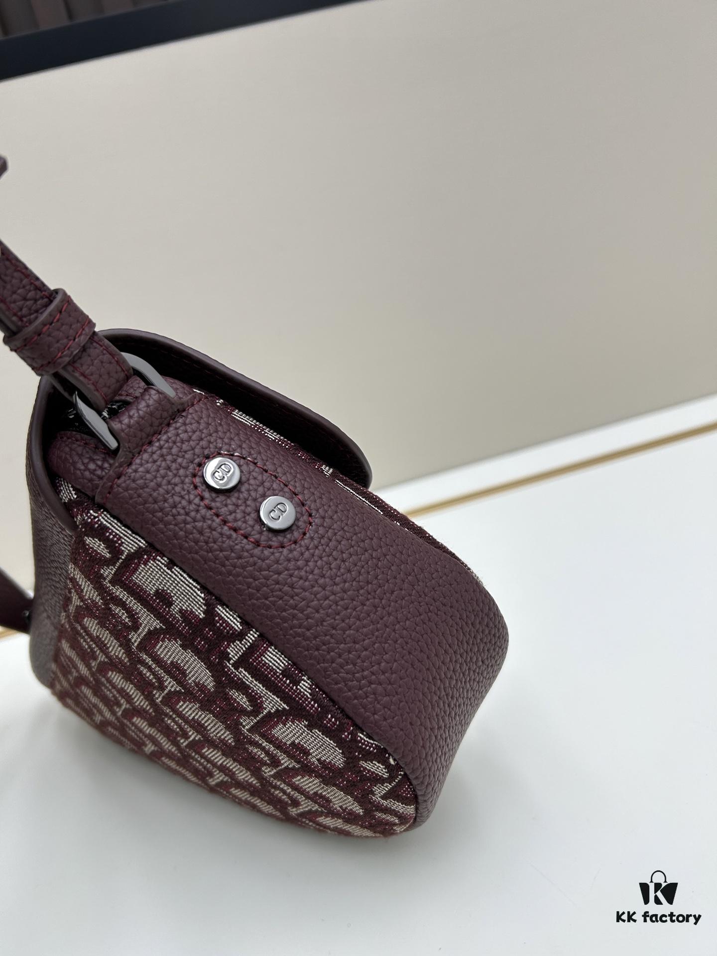 69309d126e68136f4d9ab15c This saddle bag reinterprets the classic design with a modern structure. Crafted from beige and black Oblique printed fabric, it features a signature grained black calfskin magnetic flap and hidden zip closure. The interior includes a spacious compartment and slip pocket for daily essentials. The mini style comes with an adjustable, detachable leather shoulder strap, allowing for handheld, shoulder, or crossbody wear.