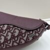 69309d126e68136f4d9ab15d This saddle bag reinterprets the classic design with a modern structure. Crafted from beige and black Oblique printed fabric, it features a signature grained black calfskin magnetic flap and hidden zip closure. The interior includes a spacious compartment and slip pocket for daily essentials. The mini style comes with an adjustable, detachable leather shoulder strap, allowing for handheld, shoulder, or crossbody wear.