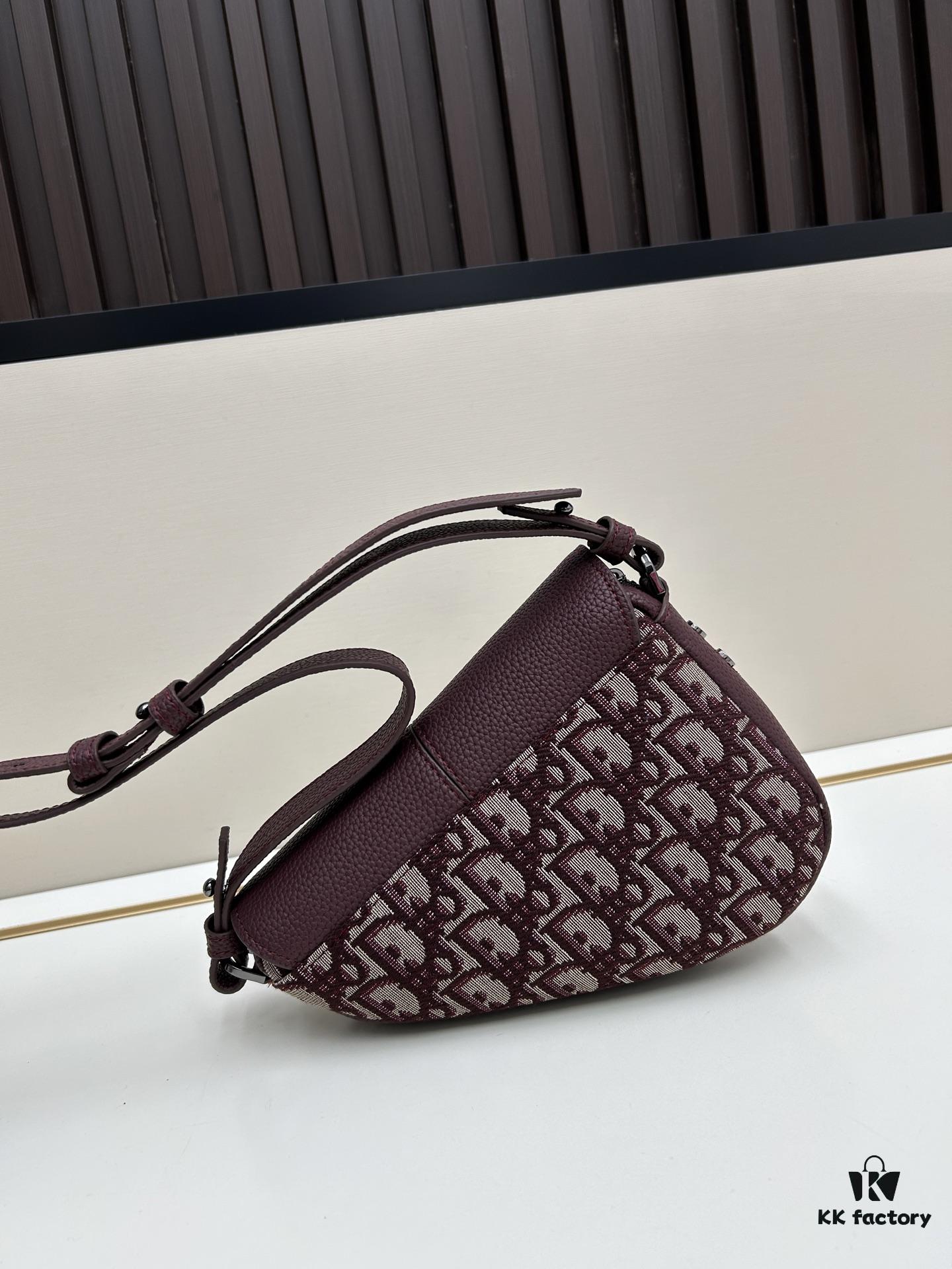 69309d136e68136f4d9ab15e This saddle bag reinterprets the classic design with a modern structure. Crafted from beige and black Oblique printed fabric, it features a signature grained black calfskin magnetic flap and hidden zip closure. The interior includes a spacious compartment and slip pocket for daily essentials. The mini style comes with an adjustable, detachable leather shoulder strap, allowing for handheld, shoulder, or crossbody wear.