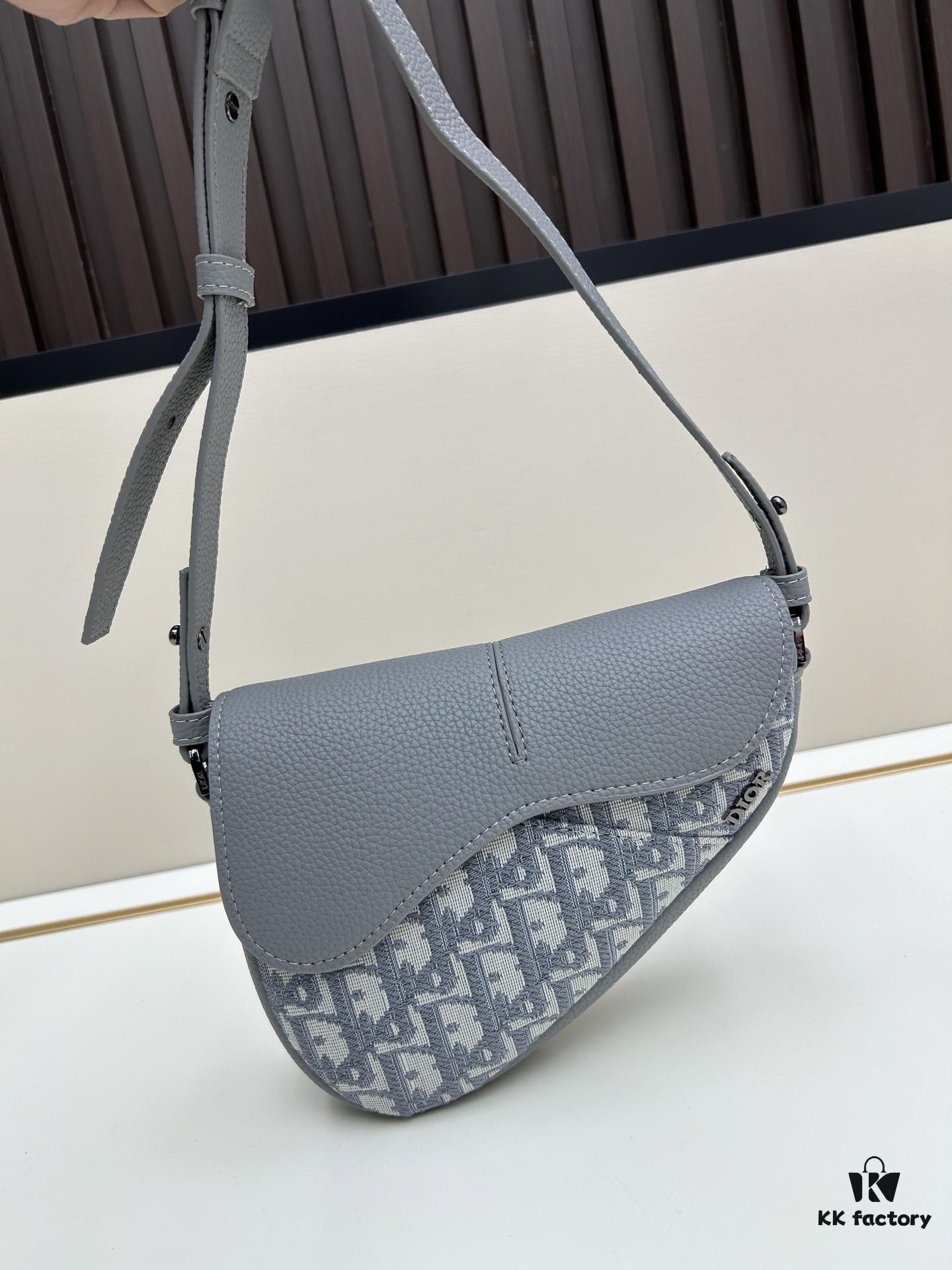 69309d1a6e68136f4d9ab169 This saddle bag reinterprets the classic design with a modern structure. Crafted from beige and black Oblique print fabric, it features a signature black grained calfskin magnetic flap and a concealed zip closure. The interior includes a large compartment and slip pockets for organizing daily essentials. The mini style comes with an adjustable, detachable leather shoulder strap, allowing for handheld, shoulder, or crossbody wear.
