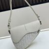 69309d1b6e68136f4d9ab16a Saddle Bag Reimagined with Modern Structure in Beige and Black Oblique Print