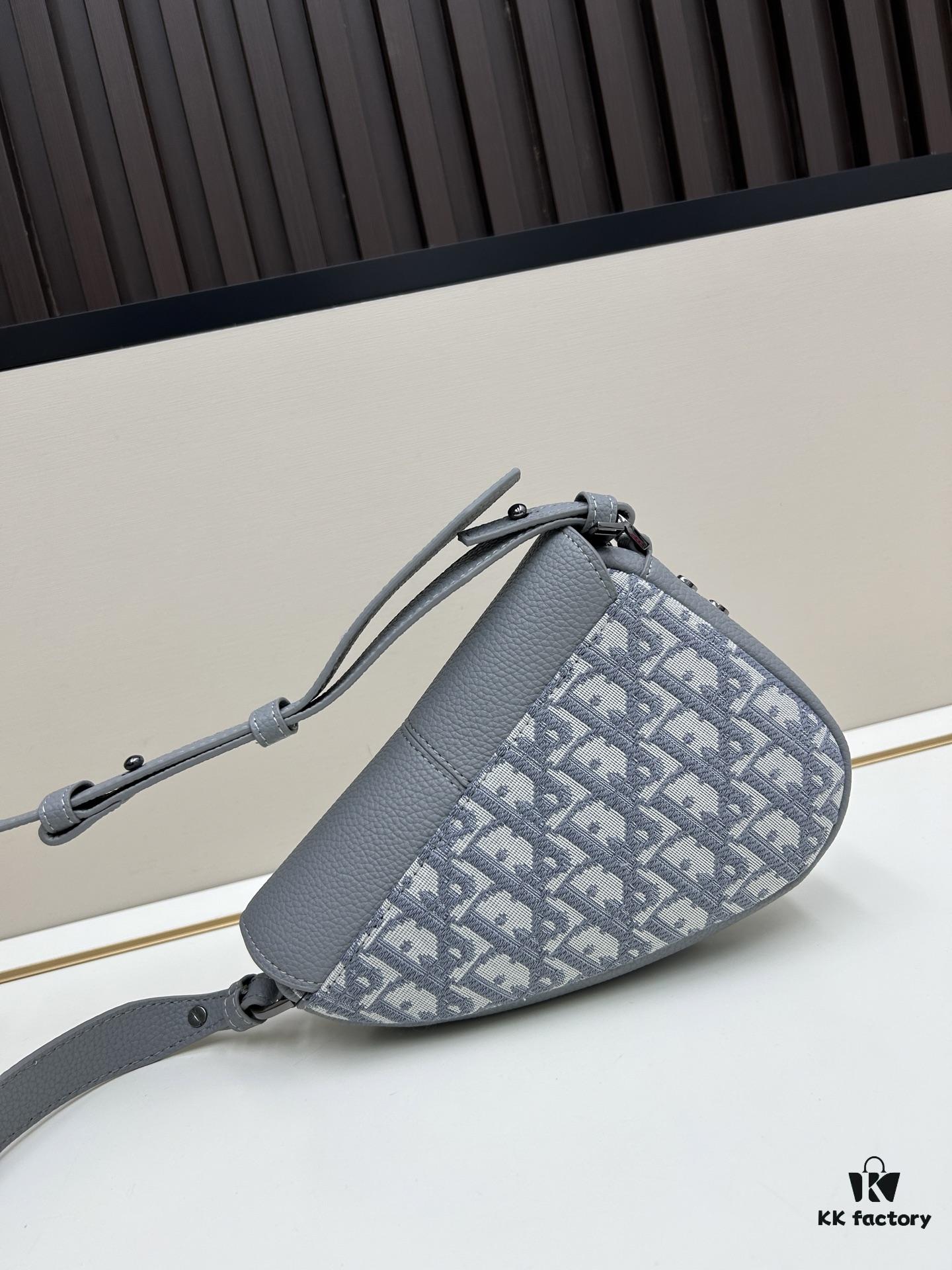 69309d1d6e68136f4d9ab16b This saddle bag reinterprets the classic design with a modern structure. Crafted from beige and black Oblique print fabric, it features a signature black grained calfskin magnetic flap and a concealed zip closure. The interior includes a large compartment and slip pockets for organizing daily essentials. The mini style comes with an adjustable, detachable leather shoulder strap, allowing for handheld, shoulder, or crossbody wear.