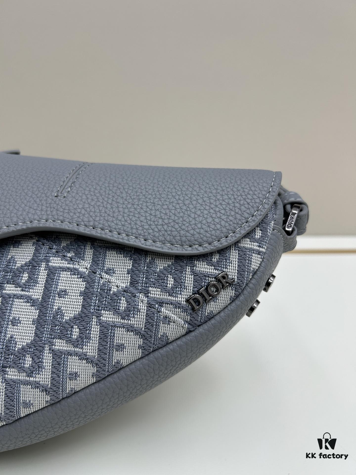 69309d1d6e68136f4d9ab16c This saddle bag reinterprets the classic design with a modern structure. Crafted from beige and black Oblique print fabric, it features a signature black grained calfskin magnetic flap and a concealed zip closure. The interior includes a large compartment and slip pockets for organizing daily essentials. The mini style comes with an adjustable, detachable leather shoulder strap, allowing for handheld, shoulder, or crossbody wear.
