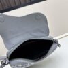 69309d1e6e68136f4d9ab16e This saddle bag reinterprets the classic design with a modern structure. Crafted from beige and black Oblique print fabric, it features a signature black grained calfskin magnetic flap and a concealed zip closure. The interior includes a large compartment and slip pockets for organizing daily essentials. The mini style comes with an adjustable, detachable leather shoulder strap, allowing for handheld, shoulder, or crossbody wear.