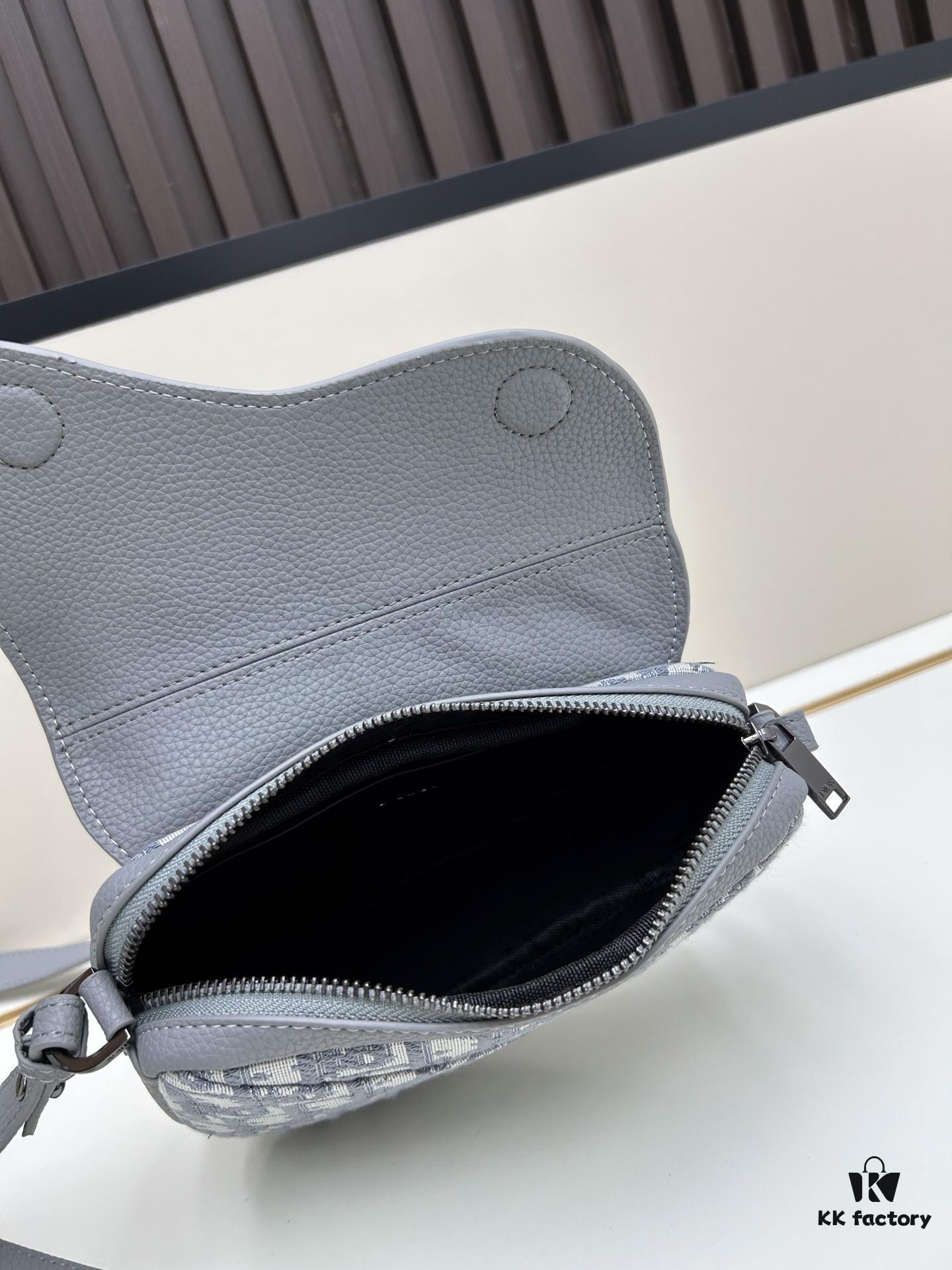 69309d1e6e68136f4d9ab16e This saddle bag reinterprets the classic design with a modern structure. Crafted from beige and black Oblique print fabric, it features a signature black grained calfskin magnetic flap and a concealed zip closure. The interior includes a large compartment and slip pockets for organizing daily essentials. The mini style comes with an adjustable, detachable leather shoulder strap, allowing for handheld, shoulder, or crossbody wear.