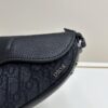 69309d216e68136f4d9ab171 This saddle bag reinterprets the classic design with a modern structure. Crafted from beige and black Oblique printed fabric, it features a signature black grained calfskin magnetic flap and a concealed zip closure. The interior includes a large compartment and slip pockets for organizing daily essentials. This mini style comes with an adjustable and detachable leather shoulder strap, allowing for versatile wear as a handheld, shoulder, or crossbody bag.