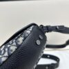 69309d226e68136f4d9ab172 This saddle bag reinterprets the classic design with a modern structure. Crafted from beige and black Oblique printed fabric, it features a signature black grained cowhide leather magnetic flap and a concealed zip closure. The interior includes a large compartment and slip pockets for daily essentials. The mini style comes with an adjustable, detachable leather shoulder strap, allowing versatile wear as a top handle, shoulder bag, or crossbody.