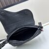 69309d246e68136f4d9ab174 This saddle bag reinterprets the classic design with a modern structure. Crafted from beige and black Oblique printed fabric, it features a signature black grained calfskin magnetic flap and a concealed zip closure. The interior includes a large compartment and slip pockets for organizing daily essentials. This mini style comes with an adjustable and detachable leather shoulder strap, allowing for versatile wear as a handheld, shoulder, or crossbody bag.