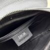69309d2e6e68136f4d9ab185 This saddle bag reinterprets the classic design with a modern structure. Crafted from beige and black Oblique print fabric, it features a signature black grained calfskin magnetic flap and a concealed zip closure. The interior includes a large compartment and slip pockets for organizing daily essentials. The mini style comes with an adjustable, detachable leather shoulder strap, allowing for handheld, shoulder, or crossbody wear.