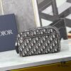 6930a71d6e68136f4d9ac46d This toiletry bag combines practical functionality with minimalist design, crafted in beige and black Oblique printed fabric with black grained leather trims, featuring the Dior logo on the front.