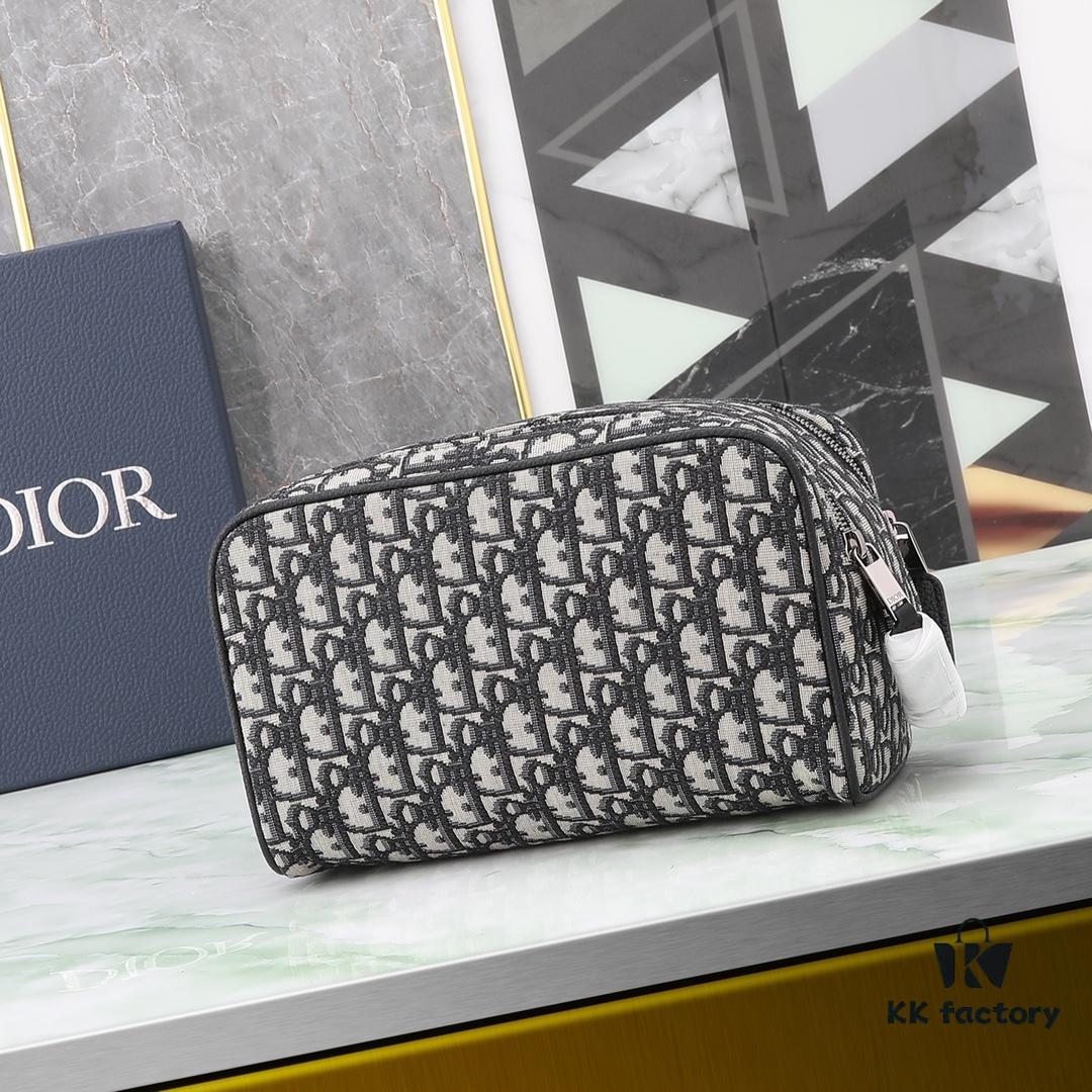 6930a71e6e68136f4d9ac470 This toiletry bag combines practical functionality with minimalist design, crafted in beige and black Oblique printed fabric with black grained leather trims, featuring the Dior logo on the front.