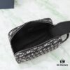 6930a71f6e68136f4d9ac472 This toiletry bag combines practical functionality with minimalist design, crafted in beige and black Oblique printed fabric with black grained leather trims, featuring the Dior logo on the front.