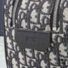 6930a71f6e68136f4d9ac473 This toiletry bag combines practical functionality with minimalist design, crafted in beige and black Oblique printed fabric with black grained leather trims, featuring the Dior logo on the front.