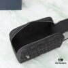This toiletry bag combines practical functionality with minimalist design. Crafted from black Oblique-print fabric, it features grained calfskin leather trims in matching tones and is adorned with a Dior signature on the front. The front features a zip pocket, a spacious main zipped compartment, and two slip pockets. Equipped with a leather handle, it can be carried by hand or stored inside various handbags.