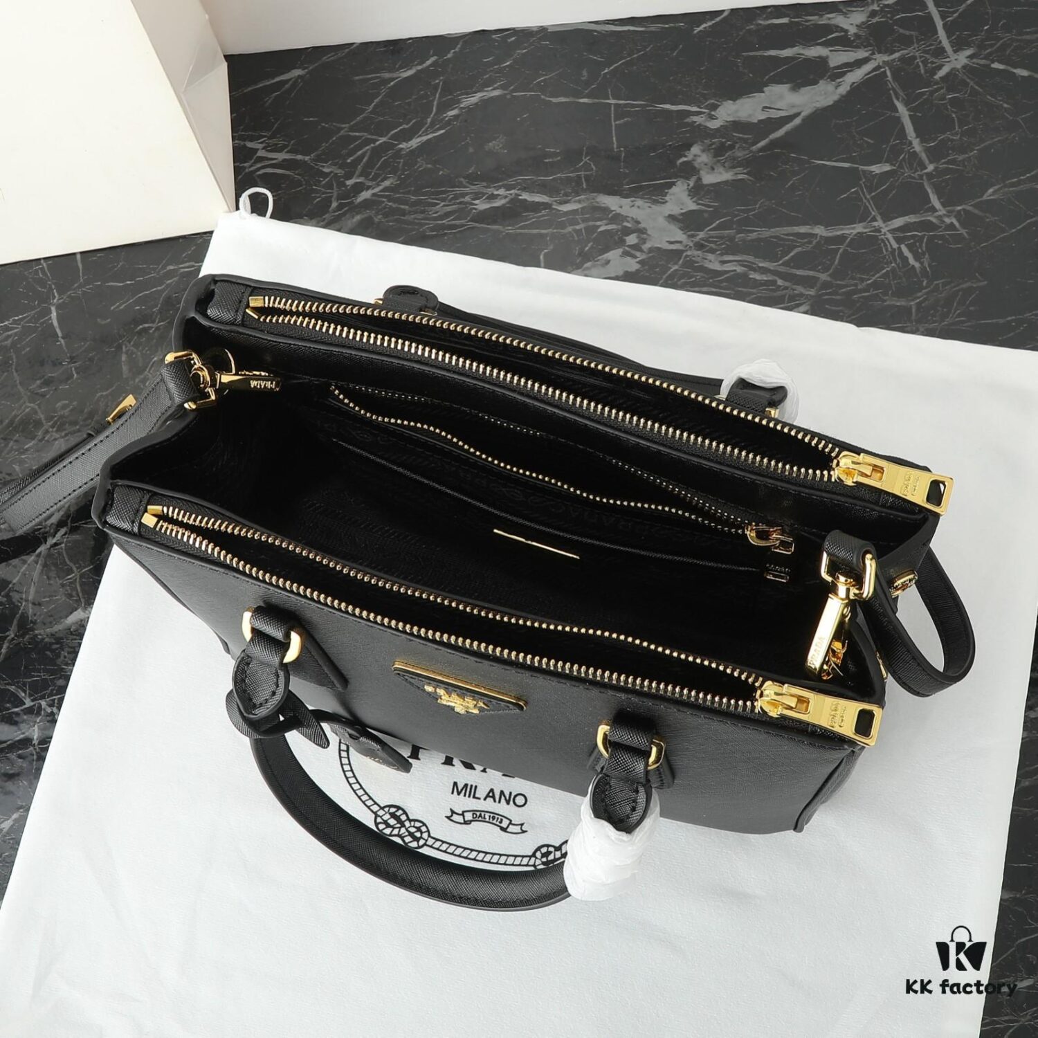 6930b9dd6e68136f4d9ae5fc House Super Hot Killer Bag, Saffiano Leather, Dual Top Handles, Detachable Adjustable Leather Shoulder Strap, Gold-Tone Hardware, Triangle Logo with Metal Lettering on Leather, Snap Button Closure on Side, Two Outer Zip Pockets, Three Interior Pockets Including One with Zipper, Prada-Branded Lining