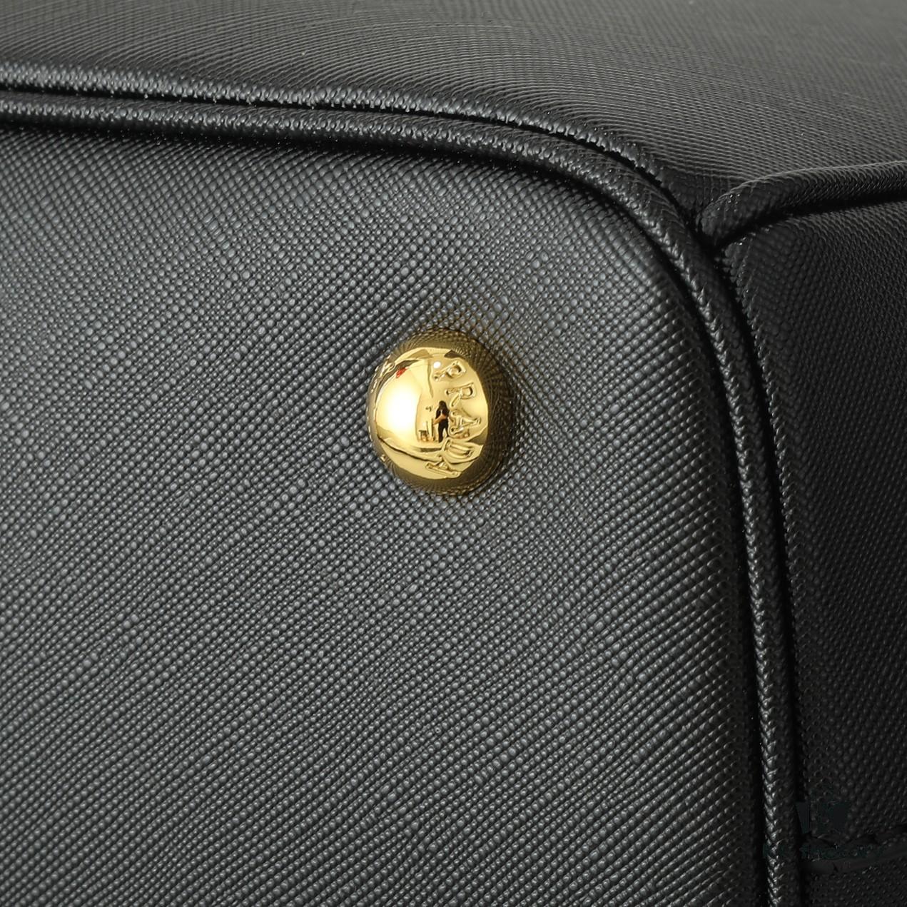6930b9e86e68136f4d9ae60d House Super Hot Killer Bag, Saffiano Leather, Dual Top Handles, Detachable Adjustable Leather Shoulder Strap, Gold-Tone Hardware, Triangle Logo with Metal Lettering on Leather, Snap Button Closure on Side, Two Outer Zip Pockets, Three Interior Pockets Including One with Zipper, Prada-Branded Lining