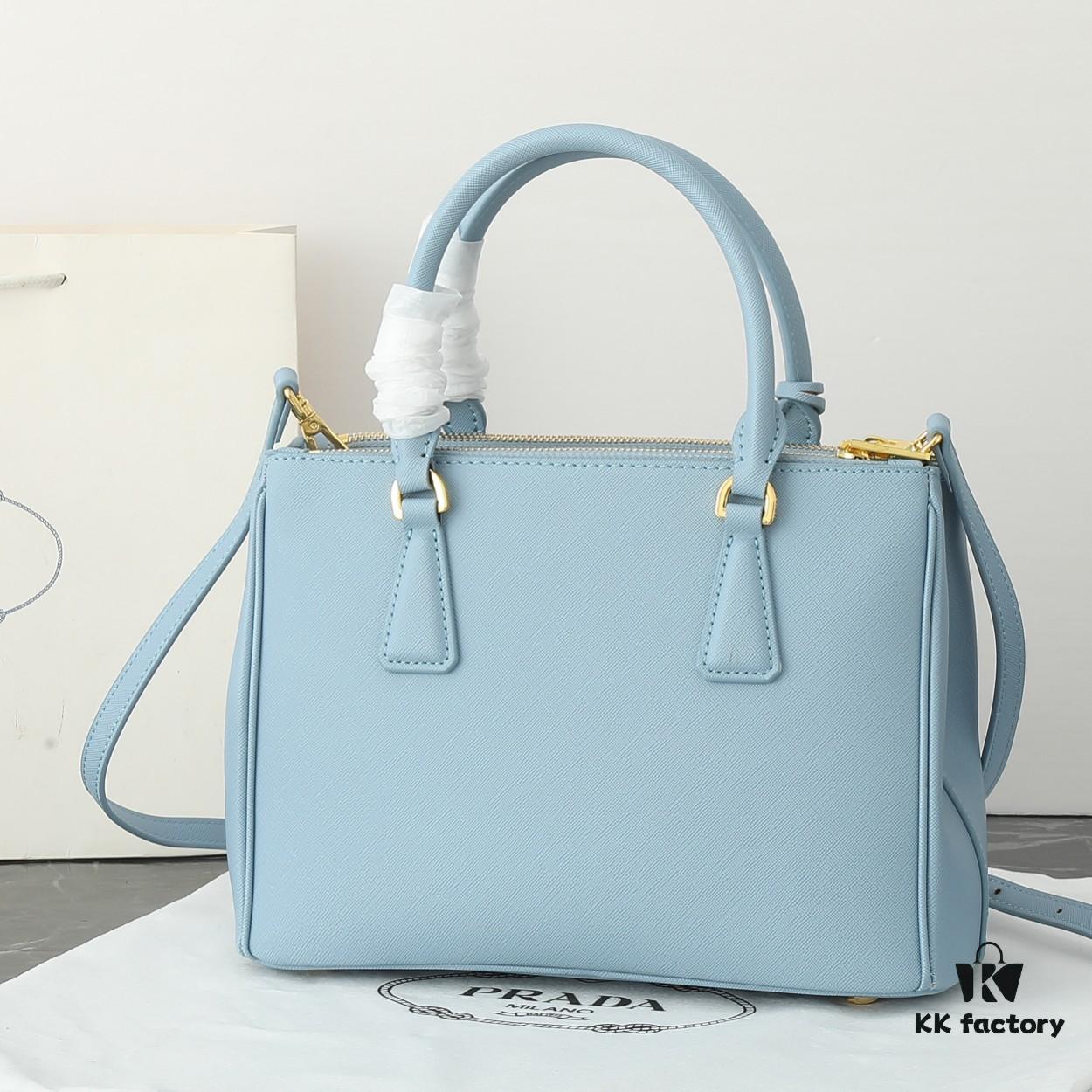 6930b9ea6e68136f4d9ae610 Model 1018 Home Super Hot Killer Bag, Saffiano Leather with Dual Top Handles, Detachable Adjustable Leather Shoulder Strap, Gold-Plated Hardware, Metal Logo Lettering on Triangular Leather Patch, Snap Button Closure on Side, Two Exterior Zip Pockets, Three Interior Pockets Including One Zip Pocket, Prada-Branded Lining