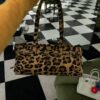 6930c1066e68136f4d9af1e4 Prada Holidays ✨||| This year's Holiday collection is absolutely stunning—featuring the new leopard-print pony hair version of the best-selling bag, a wild expression of boldness. The classic lamb fur and black velvet styles remain must-have pieces for holiday season essentials.
