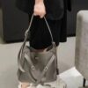 6930e22f6e68136f4d9b2418 New Balenciaga Winter 24 Collection Re-See Shoulder Bucket Bag, Top-Grain Leather, Minimalist Luxury Design, Upcycled Motorbike Glove Handbag with Keychain Closure, Effortless Chic Style