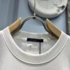 6930fb146e68136f4d9b4644 Louis Vuitton Short Sleeve T-Shirt with Leather Patch Signature Detail