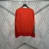 6931a058ccd8ab3d7af941de DIOR 25SS New Arrival Knitwear from the DIOR AND KAWS Limited Collection. Crafted from red and burgundy wool knit fabric, one sleeve features the DIOR AND KAWS signature embroidery, reinterpreting the Dior logo with a vibrant serpentine motif. The hem and cuffs feature contrasting details, perfect for pairing with classic jeans or shorts to create a striking look.