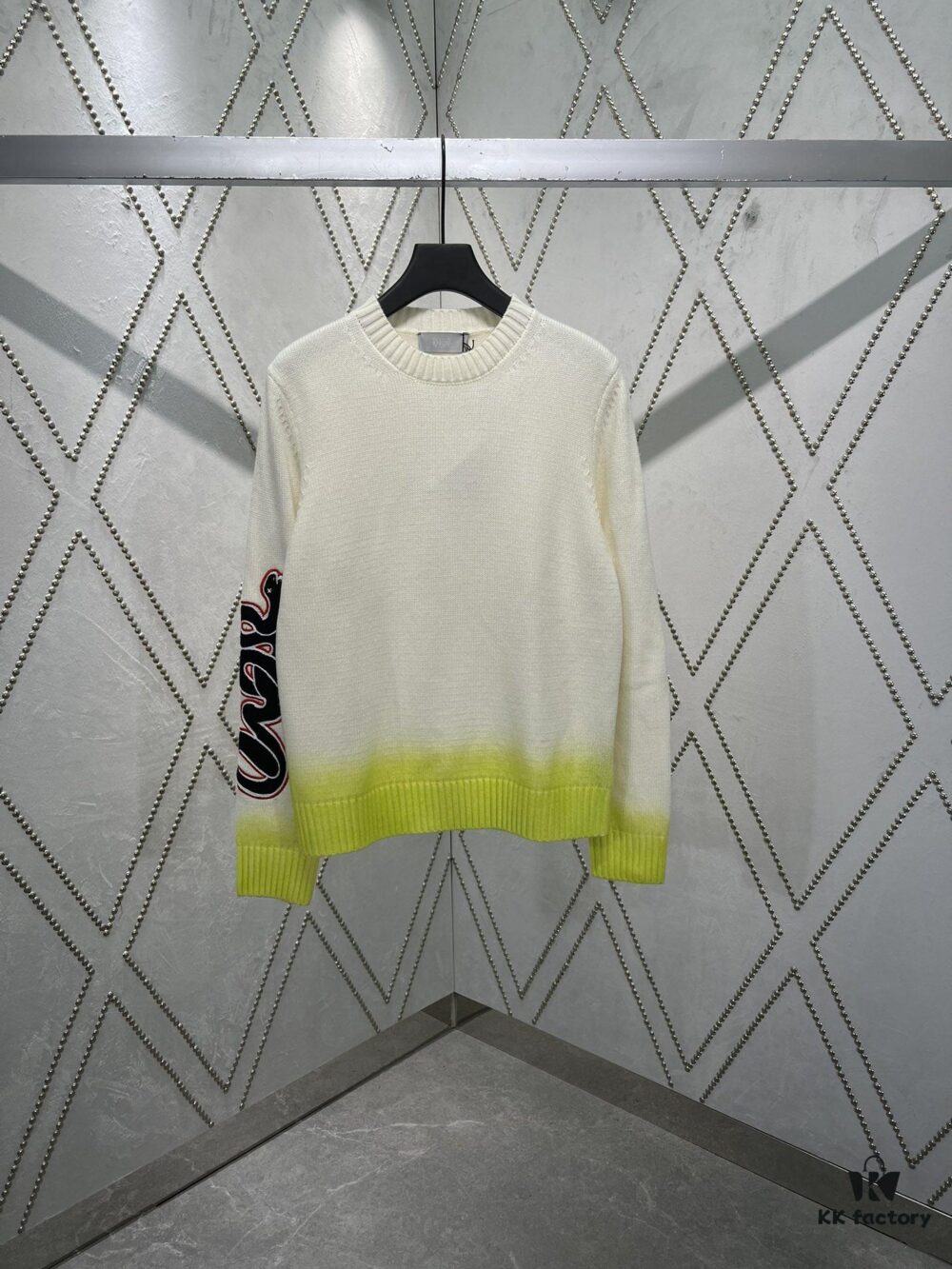 6931a059ccd8ab3d7af941e6 Dior 25SS New Arrival Knitwear from the DIOR AND KAWS Limited Edition Collection. Crafted from white and yellow wool knit fabric, one sleeve features the DIOR AND KAWS signature embroidery, reinterpreting the Dior logo with a colorful serpentine design. The hem and cuffs are finished with contrasting details, perfect for pairing with classic jeans or shorts to create a striking look.