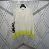 6931a059ccd8ab3d7af941e6 Dior 25SS New Arrival Knitwear from the DIOR AND KAWS Limited Edition Collection. Crafted from white and yellow wool knit fabric, one sleeve features the DIOR AND KAWS signature embroidery, reinterpreting the Dior logo with a colorful serpentine design. The hem and cuffs are finished with contrasting details, perfect for pairing with classic jeans or shorts to create a striking look.
