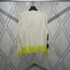 6931a059ccd8ab3d7af941e7 Dior 25SS New Arrival Knitwear from the DIOR AND KAWS Limited Edition Collection. Crafted from white and yellow wool knit fabric, one sleeve features the DIOR AND KAWS signature embroidery, reinterpreting the Dior logo with a colorful serpentine design. The hem and cuffs are finished with contrasting details, perfect for pairing with classic jeans or shorts to create a striking look.